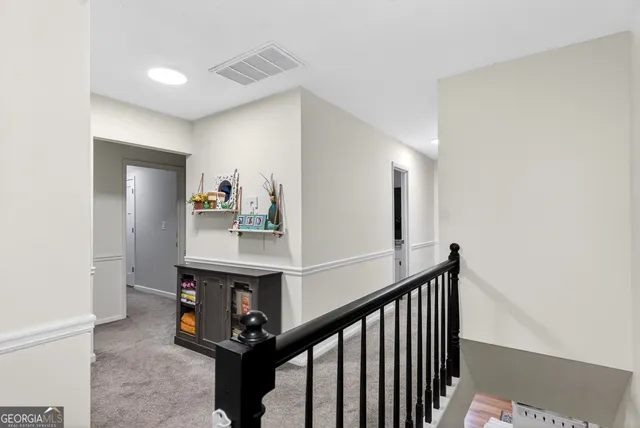a living room with furniture a flat screen tv and bookshelf