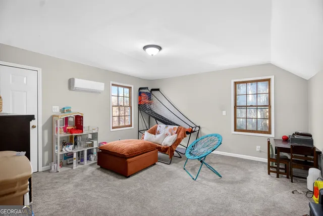 view of a bedroom with toys and wooden floor
