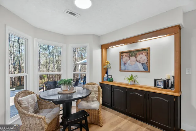 a kitchen with a sink a stove and chairs
