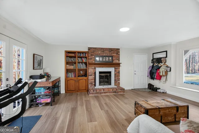 a living room with furniture a flat screen tv and a fireplace