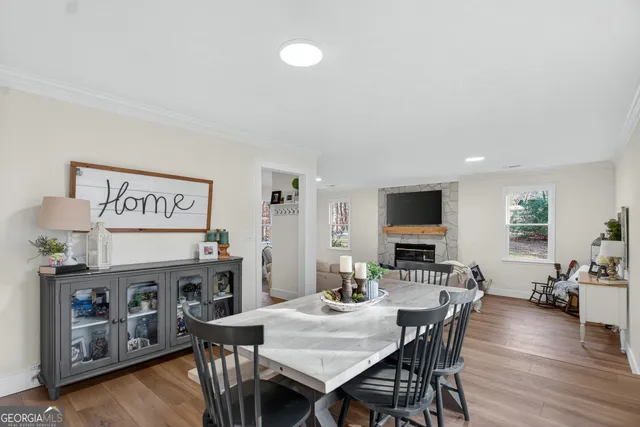 a view of a dining room with furniture and wooden floor