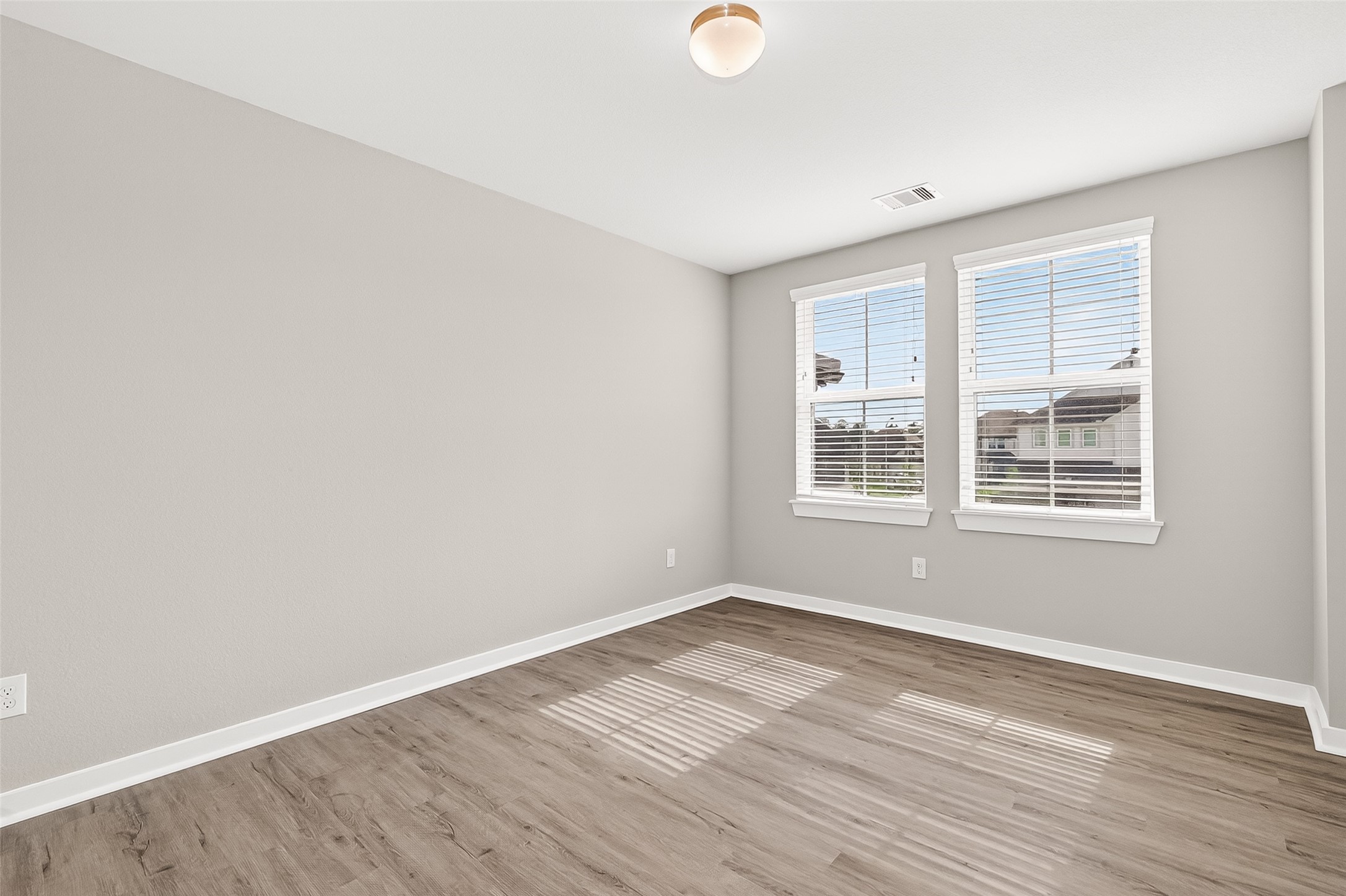 2142 Reed Cave Lane Spring, TX 77386 - Photo 34 of 50 an empty room with wooden floor and windows