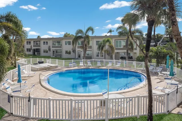 a swimming pool with outdoor seating and yard