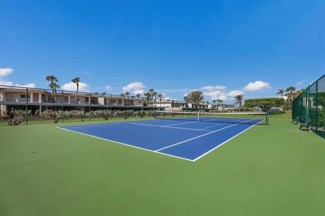 a view of tennis court with outdoor seating