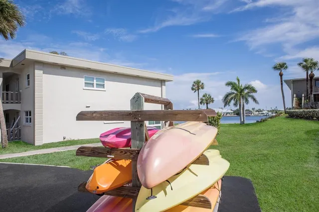 a view of a porch with furniture and a yard