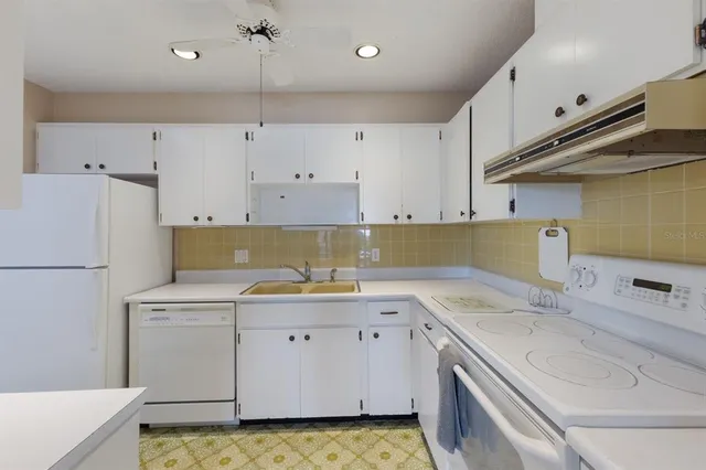 a kitchen with a sink a stove and cabinets