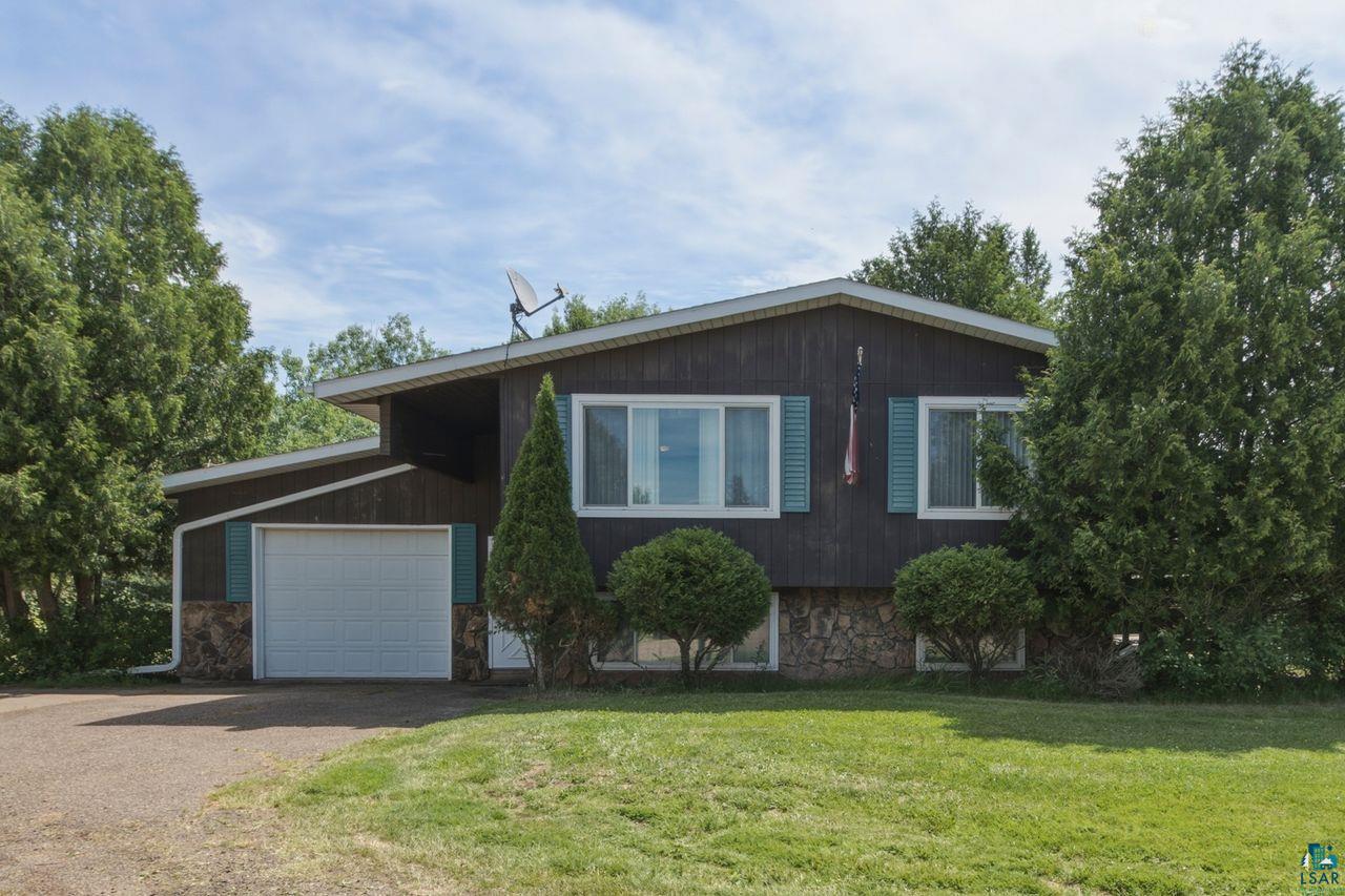 61018 Dahlstrom Road Ashland, WI 54806 - Photo 28 of 28 Split-level residence featuring dark wood siding, a stone base, and a white garage door