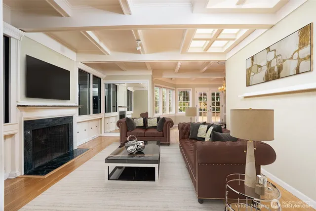 a living room with furniture fireplace and flat screen tv