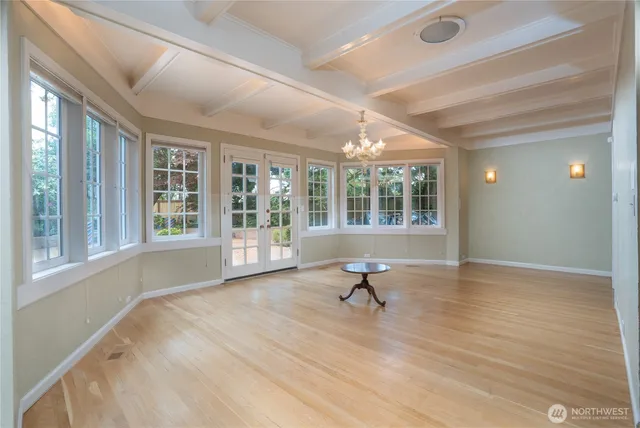 a view of wooden floor and windows in a room