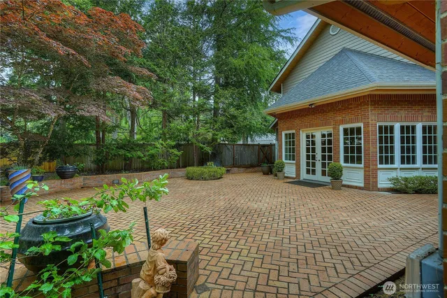 a front view of a house with a yard and potted plants