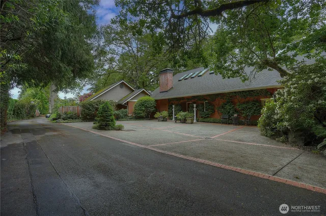 a wooden house with a large tree in front of it