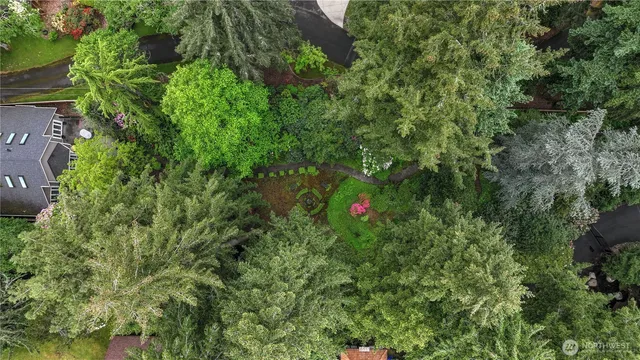 a backyard of a house with lots of green space and a fountain