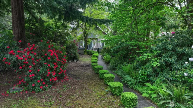 a view of a flower garden in front of house