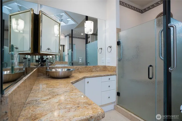 a spacious bathroom with a double vanity sink a mirror and a shower