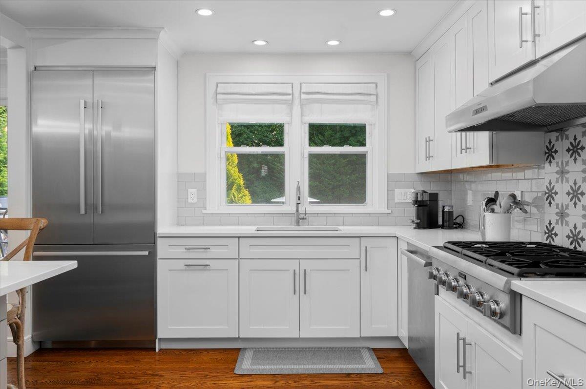 33 Temple Street Harrison, NY 10528 - Photo 12 of 31 a kitchen with stainless steel appliances granite countertop a sink a stove and a refrigerator