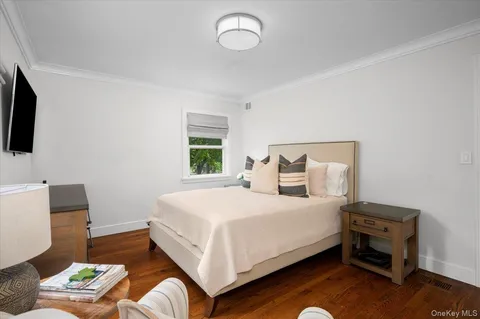 a bedroom with a bed and a television