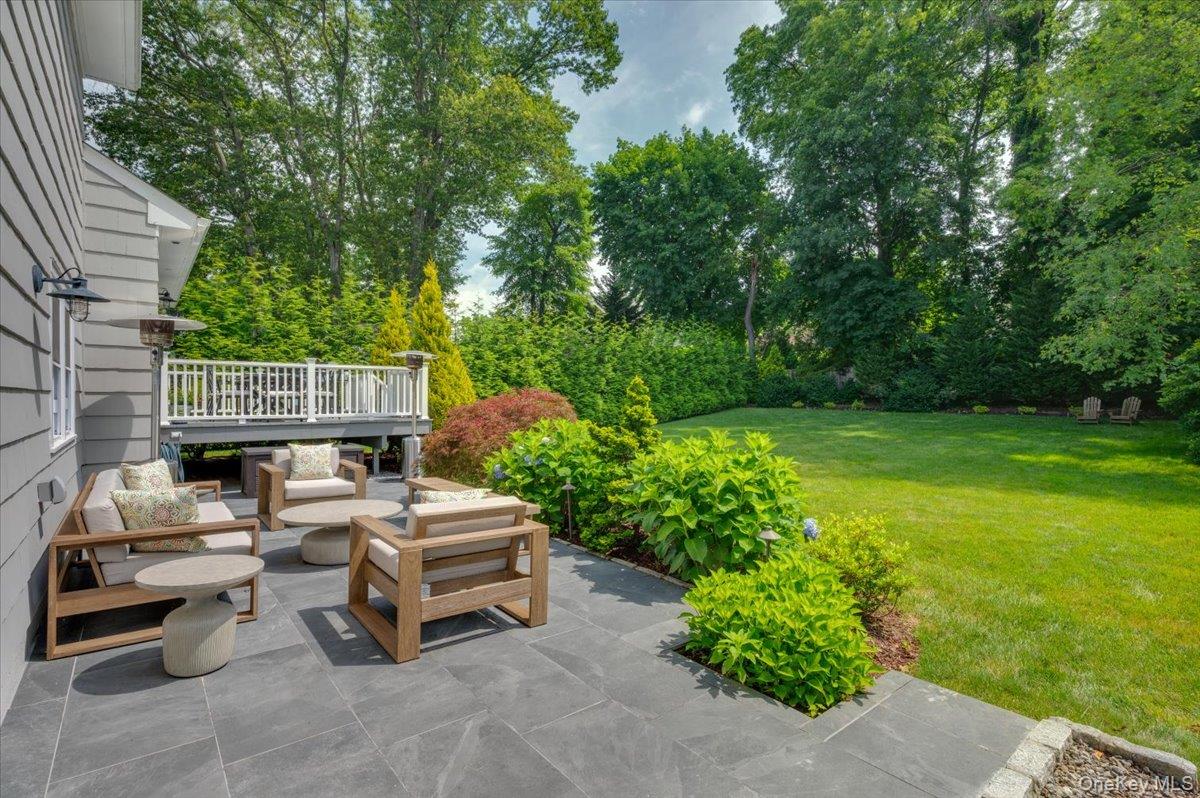 33 Temple Street Harrison, NY 10528 - Photo 23 of 31 a car parked in the yard next to a road