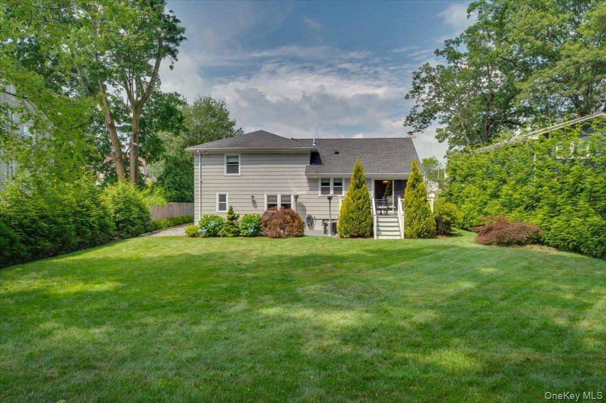 33 Temple Street Harrison, NY 10528 - Photo 28 of 31 a view of a house with yard and a garden