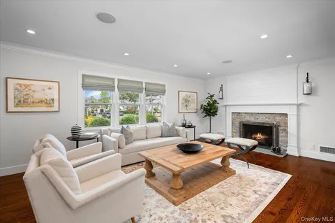 a living room with furniture fireplace and window