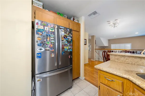 a kitchen with stainless steel appliances granite countertop a refrigerator and a stove