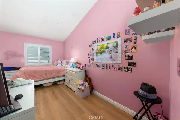 a bedroom with bed and a window