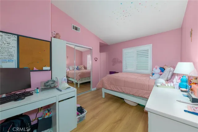 a bedroom with a bed and a desk