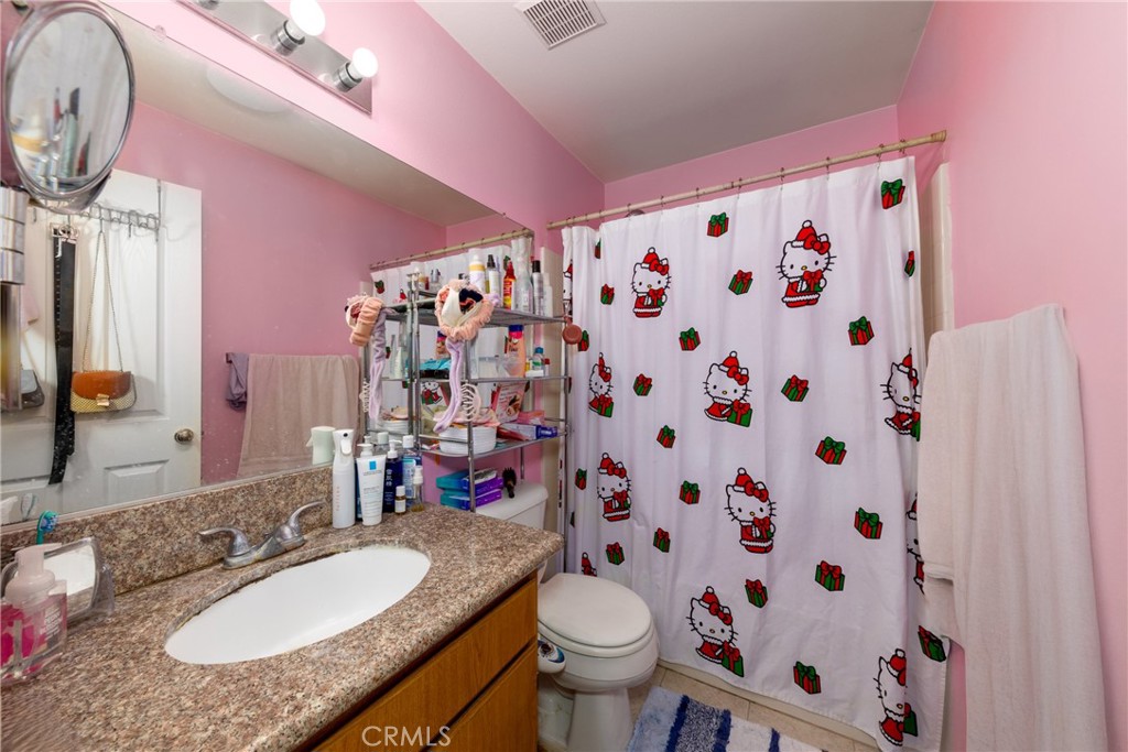 23220 Colony Park Drive Carson, CA 90745 - Photo 20 of 34 a bathroom with a granite countertop sink and a mirror