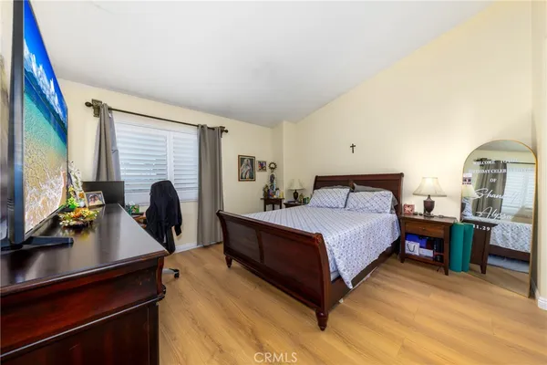 a bed room with a bed window and a television