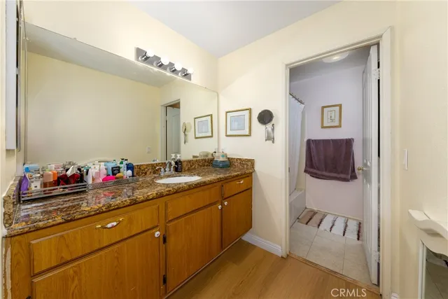 a bathroom with a sink vanity and a mirror