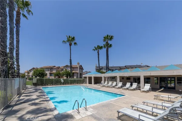 swimming pool view with a seating space