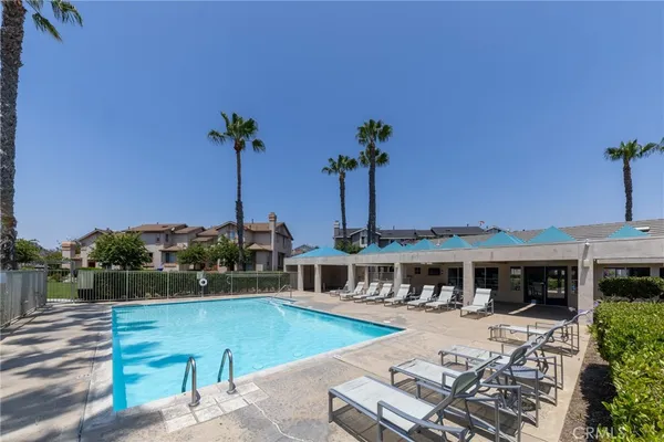 a view of a house with pool and chairs