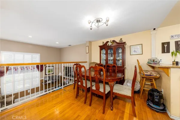a dining room with furniture and wooden floor