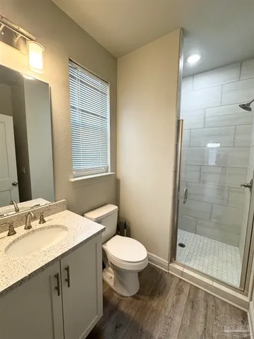a bathroom with a granite countertop sink toilet and shower