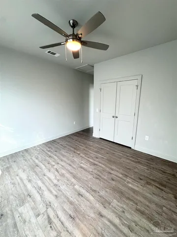 an empty room with wooden floor