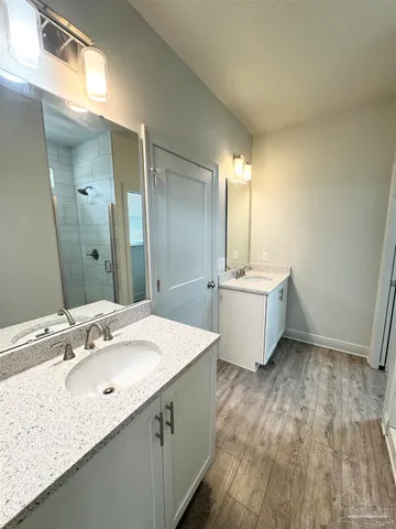 a bathroom with a double vanity sink and a mirror