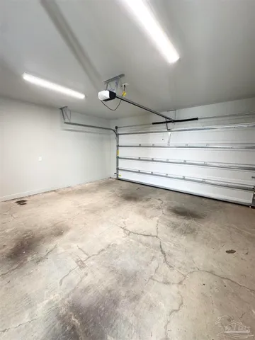 a view of a room with a dishwasher and cabinets