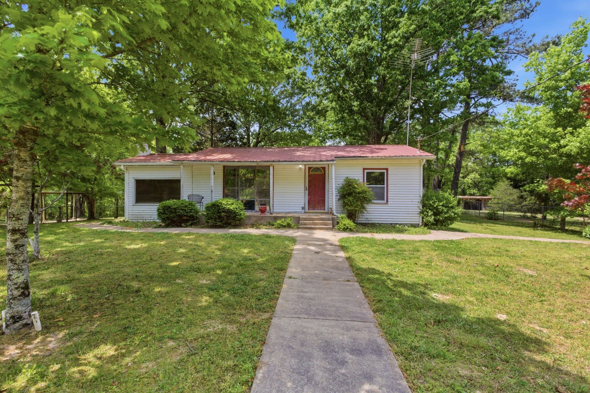 a front view of house with yard and green space