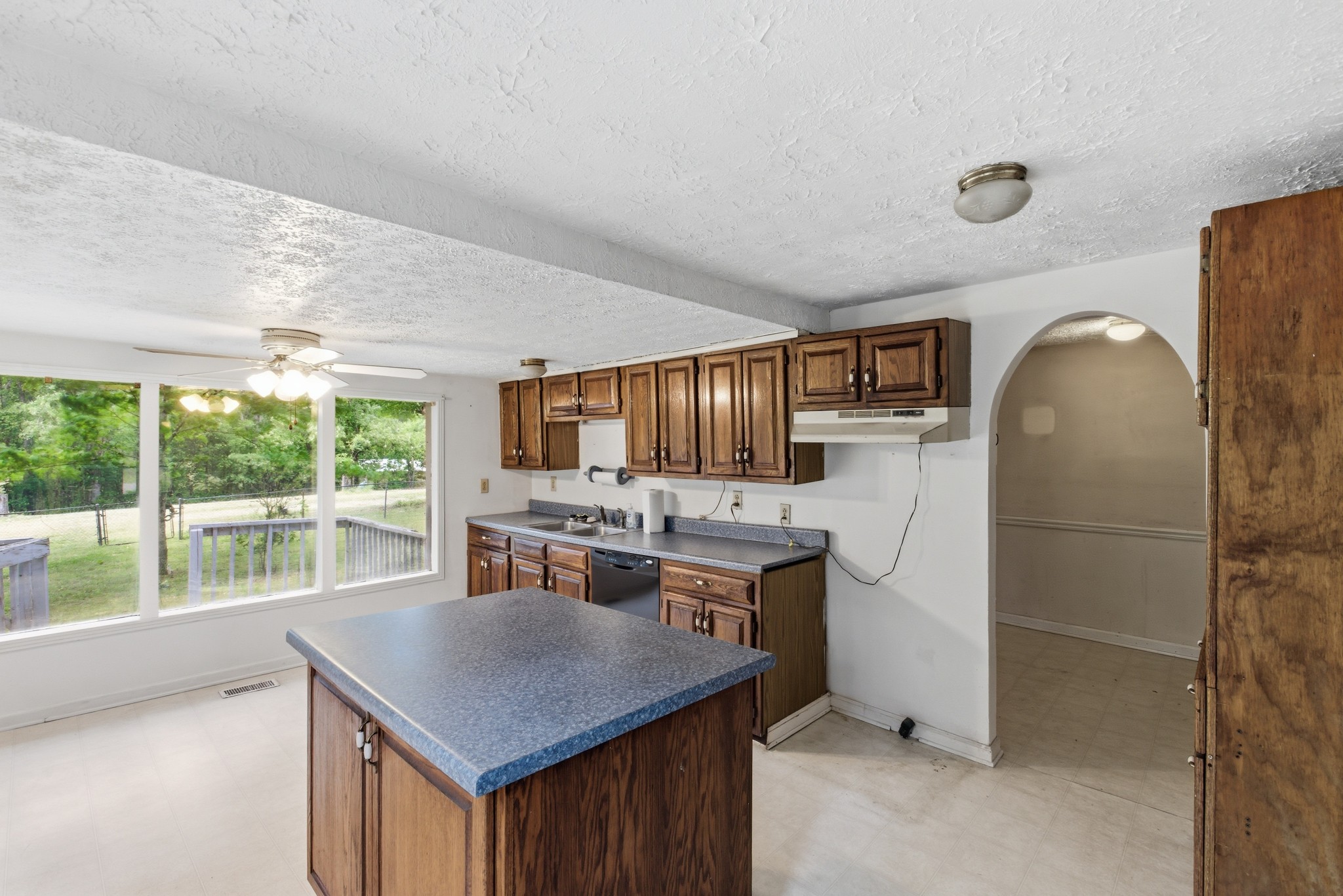10075 Buckner Ridge Road Bon Aqua, TN 37025 - Photo 11 of 20 a kitchen with a stove a refrigerator a sink dishwasher with a dining table and chairs