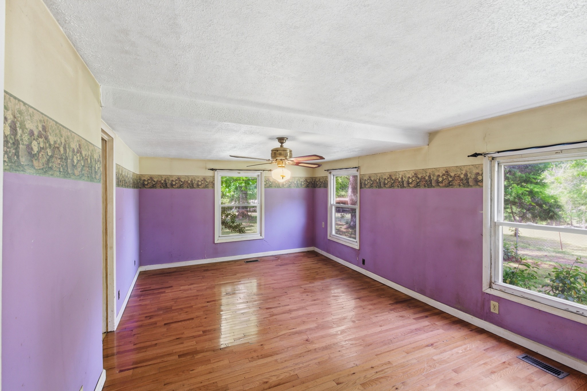 10075 Buckner Ridge Road Bon Aqua, TN 37025 - Photo 14 of 20 wooden floor in an empty room with a window