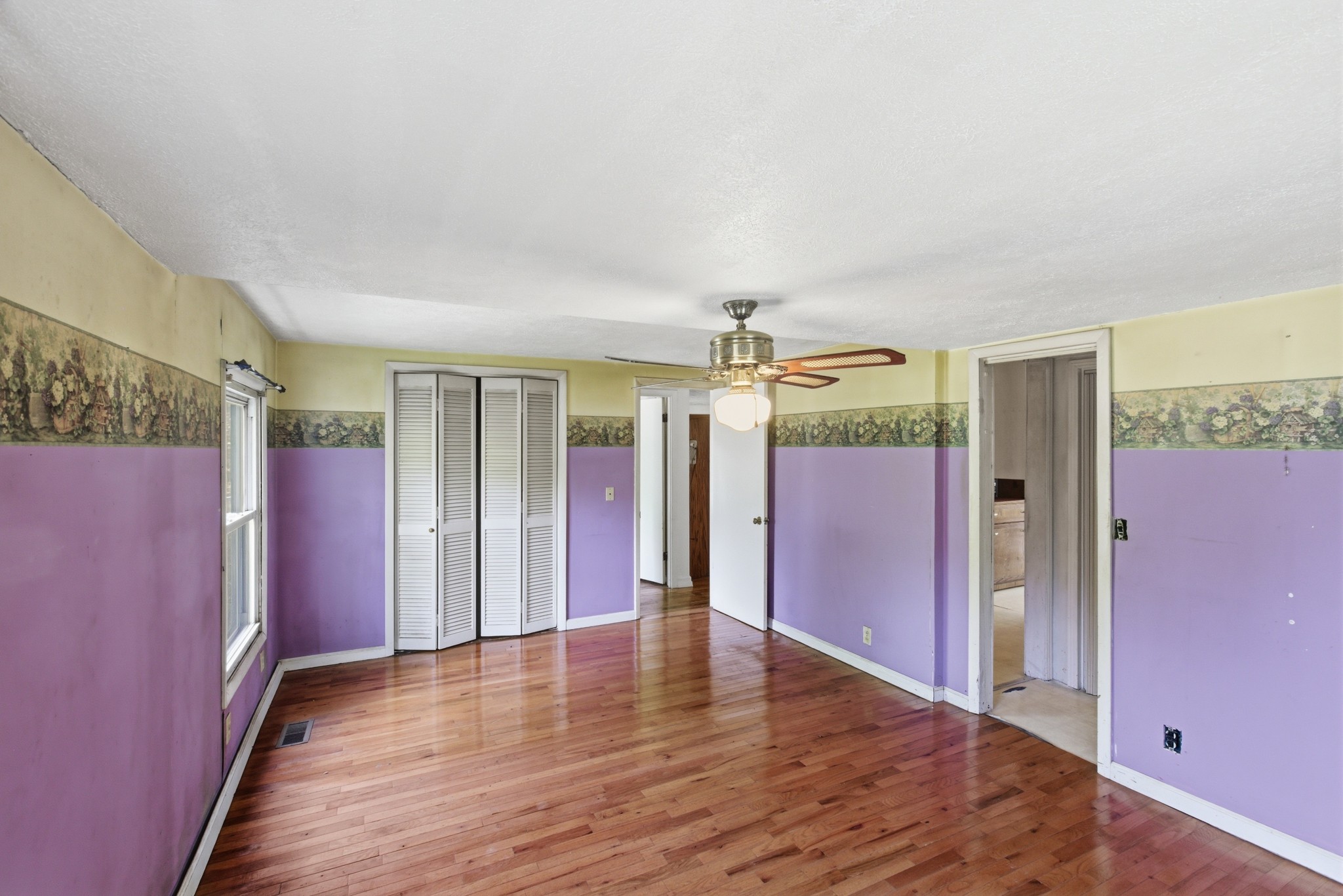 10075 Buckner Ridge Road Bon Aqua, TN 37025 - Photo 15 of 20 a view of an empty room with window and wooden floor