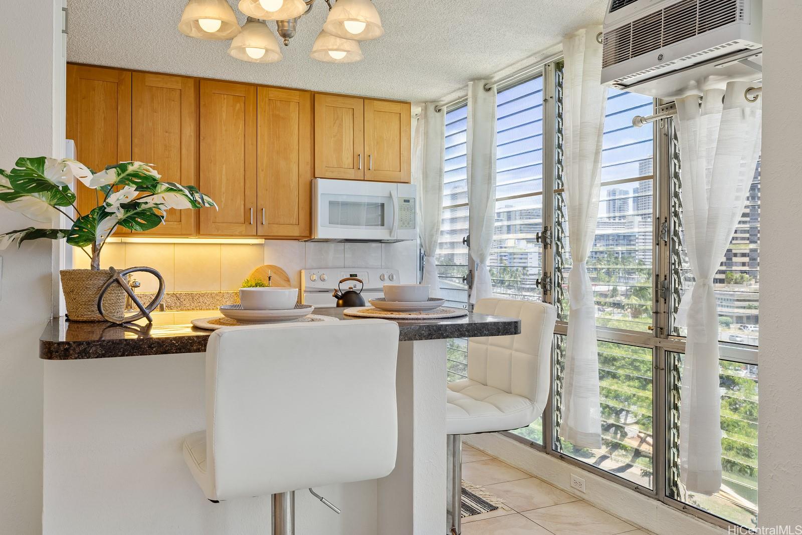 620 McCully Street, Unit 703 Honolulu, HI 96826 - Photo 8 of 25 All these windows were tinted plus you have AC to keep you cool.