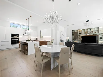 a kitchen with a sink and chairs