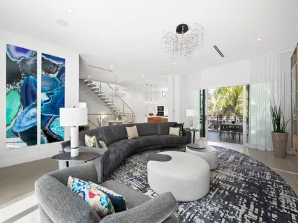 a dining room with furniture a floor to ceiling window and a potted plant