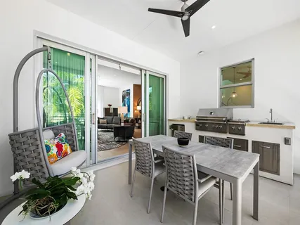 a kitchen with stainless steel appliances a table and chairs in it
