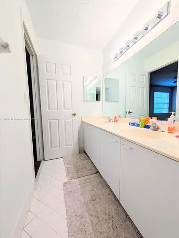 a bathroom with tub sink and mirror
