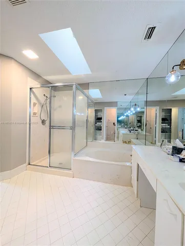 a spacious bathroom with a tub and shower