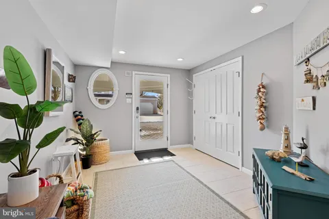 a kitchen with stainless steel appliances kitchen island granite countertop a table chairs in it and wooden floors