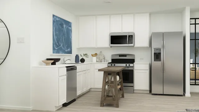 a kitchen with a refrigerator a stove a microwave and cabinets