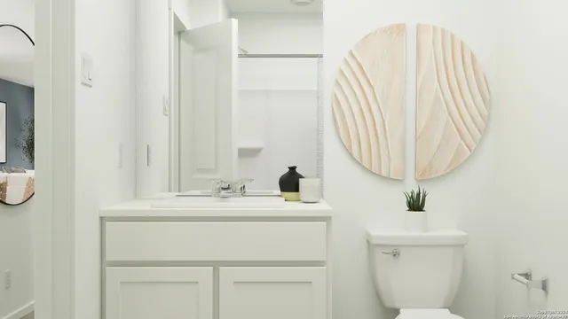 a bathroom with a sink a toilet and a mirror