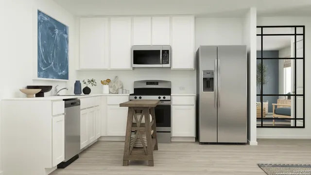 a kitchen with stainless steel appliances a refrigerator and a stove top oven